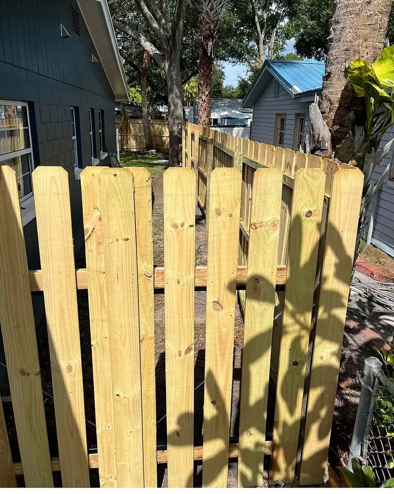 Cerca de madera tratada con puerta, recién instalada